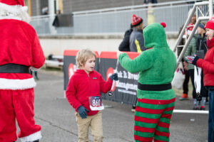 Snowflake chaser kid receiving finisher medal